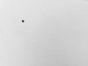 Black dot on white page